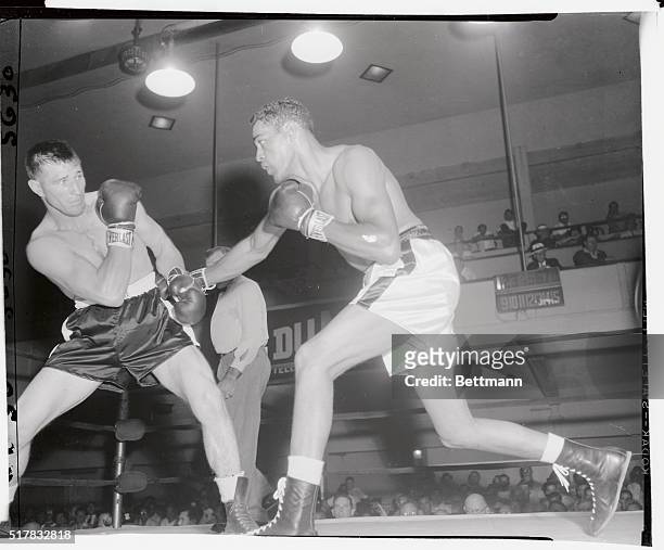 Paul Andrews, of buffalo, NY, moves in with a right on Yvon Durelle, light heavyweight King of Canada, during their schedded ten-rounder at St....