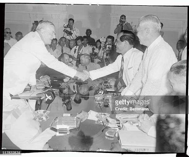 Carlos M. Garcia, vice president of the Philippine Republic, is shown shaking hands with U.S. Secretary of State John Foster Dulles when they met to...