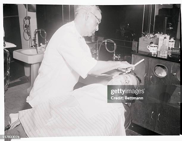 Senate barber Abe Highley gets Senator Henry Jackson, , of Washington, back into tonsorial shape here, after the Senator took the floor for the...