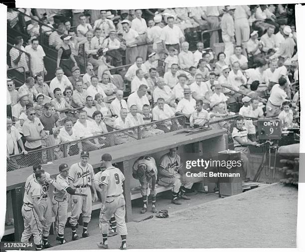 Braves stand up in the dugout to greet teammate Joe Adcock after he hit his third home run of the game in the seventh inning. In the ninth inning Joe...