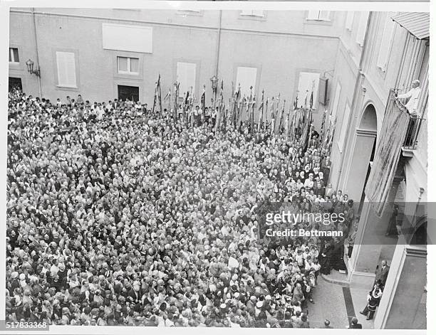 His holiness Pope Pius XII is shown , blessing a Belgian pilgrimage at his summer residence in Castelgandolfo. The throng jammed the courtyard to...