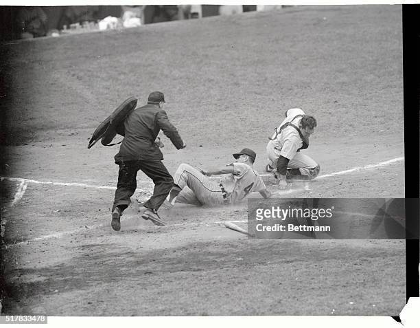 Detroit's Wayne Belardi slides home past Yank catcher Yogi Berra, scoring on Hoeft's fly to right fielder Irv Noren in 2nd frame of today's game at...