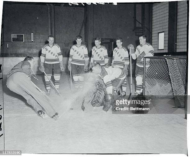 Muzz Patrick, former Ranger great and Canada greatest athlete, now Ranger coach, shows the boys how to upset the goalie by kicking a spray of ice...