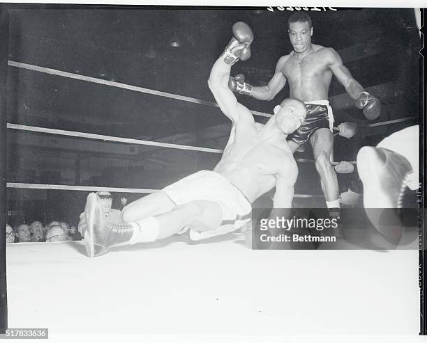 Stiff as the well known mackerel, Harold Johnson, number one light-heavyweight contender, goes to the canvas for the full count in the second round...