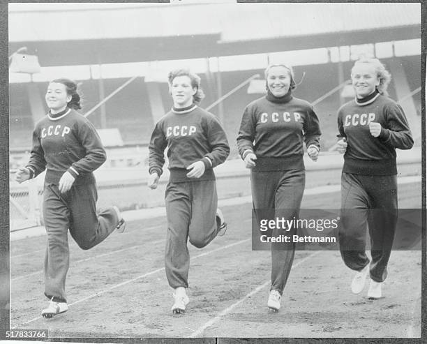 Four women member of the 70 strong Russian team are shown working out around the track at London's White City as they tuned up for the London versus...