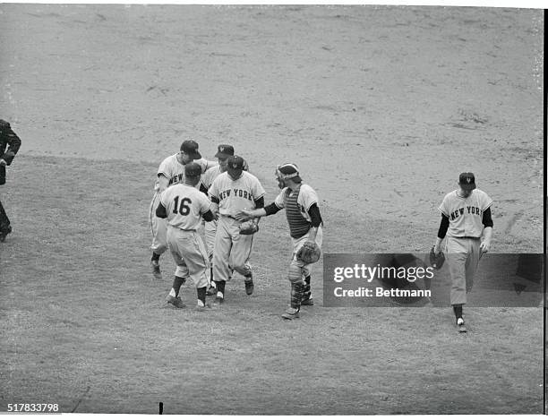 Catcher Wes Westrum, and Giant infielders Hank Thompson , Al Dark, left, and Davey Williams congratulate relief pitcher Hoyt Wilhelm after the final...