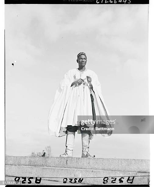 Pictured in native finery as he visited the United Nations today is the Tolon-Na Yakuba Tali, African Gold Coast tribal chief and member of...