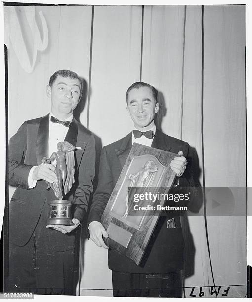 Twenty-nine year-old designer of the year James Gallanos holds the Winnie, fashion's version of the Hollywood "Oscar," awarded to him at ceremonies...