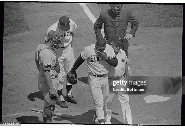 Giants centerfielder Willie Mays, , goes to one knee after he apparently had a dizzy spell while batting in the 4th inning of this Giants-Cubs game...