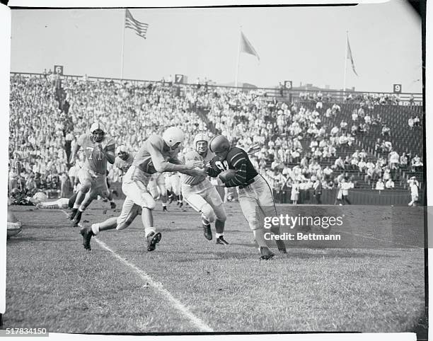 Russell, , Princeton halfback, is tackled by Black and Wilson of Columbia as he carried the ball for a six yard gain in the second quarter of the...