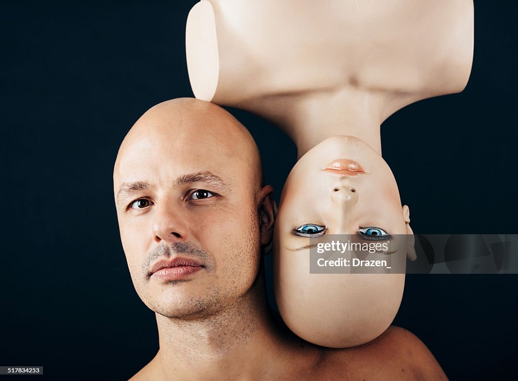 Lifestyle concept with bald man with upside down female mannequin