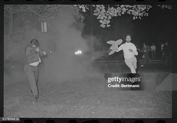 Chicago: A tear gas cloud closes over youths trying to flee after police used the chemical to disperse a mass of hippies, yippies, and other assorted...