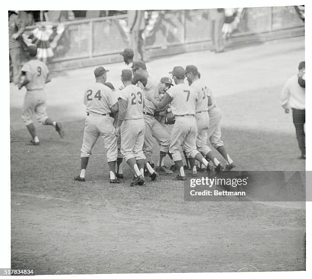 Bronx: Yankee Stadium: Teammates rush to surround Dodgers' pitcher Sandy Koufax , after he struck out Harry Bright, last Yankee to face him, to set a...