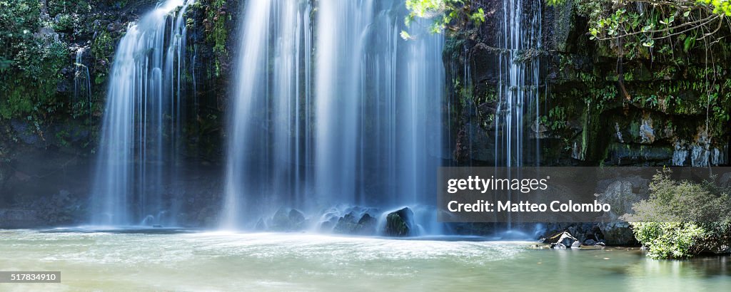 Powerful waterfall in the green forest of Costa Rica