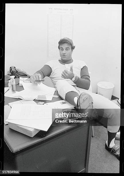 New York Mets manager Joe Torre talks to newsmen in Wrigley Field office 4/78 as he awaits word on whether game with Chicago Cubs would be called...