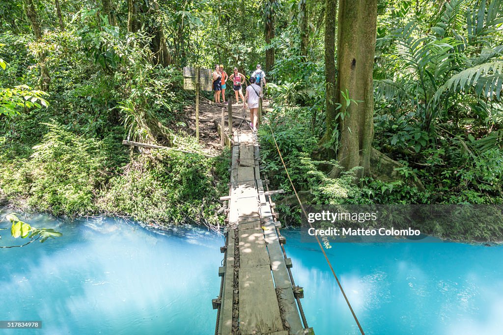 Suspension wooden bridge crossing Rio Celeste river, Costa Rica