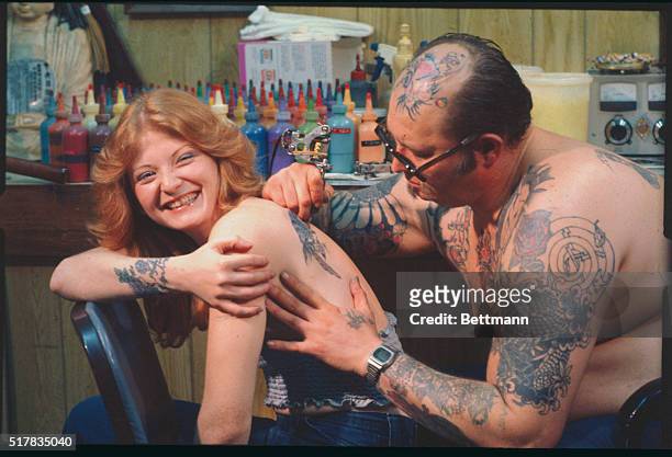 Ferndale, MI.: Mel McEihiney a tattoo artist, carefully works on a parrot tattoo on the back of Kathy Arwady an artist herself and a protege of...