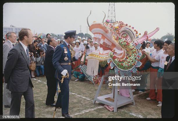 During his first official visit to the crown colony of Hong Kong, Britain's Prince Charles initiates a bamboo-and-gauze dragon as part of the...