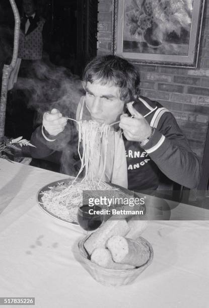 Giancarlo Usai, Olympic medalist and Italian lightweight boxing champ, eats a plate of spaghetti at San Romeo Restaurant here 4/17. Usai is here to...