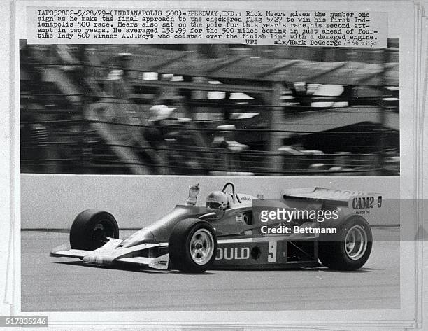 Rick Mears gives the number one sign as he makes the final approach to the checkered flag 5/27, to win his first Indianapolis 500 race. Mears also...