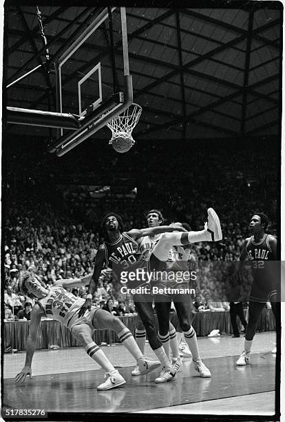 Indiana State's Larry Bird drops over backwards on a rebound attempt during the first period of the NCAA Basketball Semi-finals at the University of...
