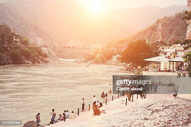 people bathe in the ganges river in rishikesh city center - rishikesh stock pictures, royalty-free photos & images