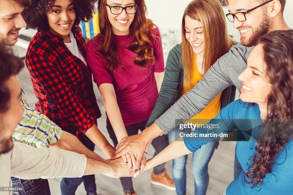 Group of friends making a pile of hands