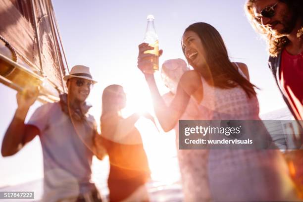 friends laughing and dancing on a yacht at sunset - yacht bildbanksfoton och bilder