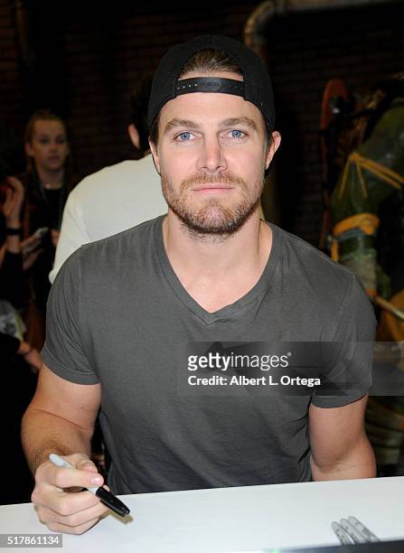 Actor Steven Amell signs autographs at the Paramount booth while promoting Teenage Mutant Ninja Turtles: Out Of The Shadows" on Day 1 of WonderCon...
