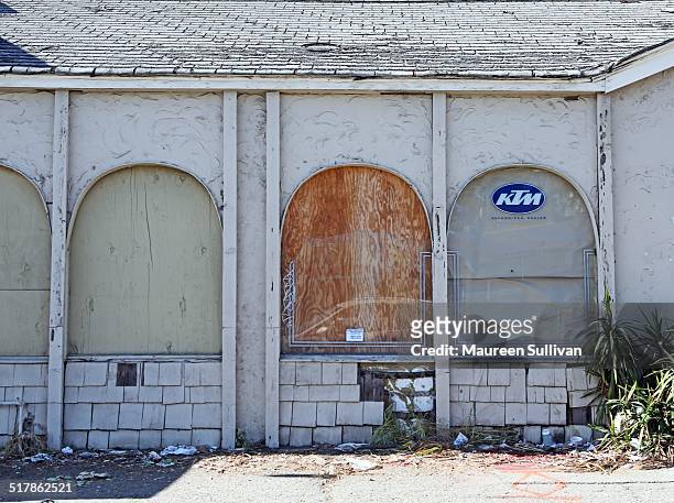 Abandoned store in Downey, California. Windows are both papered and boarded.
