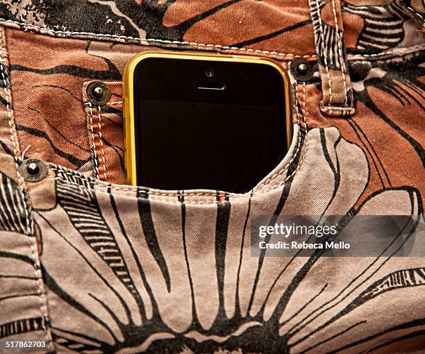 Yellow IPhone 5C in front pocket of stamped trousers