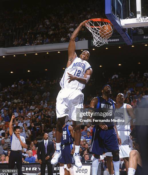 Dwight Howard of the Orlando Magic makes a slam dunk against the Dallas Mavericks at the TD Waterhouse Centre on November 9, 2004 in Orlando,...