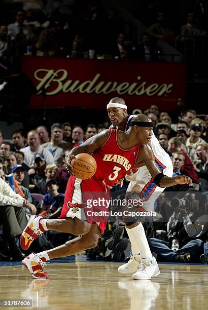 Al Harrington of the Atlanta Hawks drives to the basket against Jerome Williams of the New York Knicks on November 23, 2004 at Madison Square Garden...