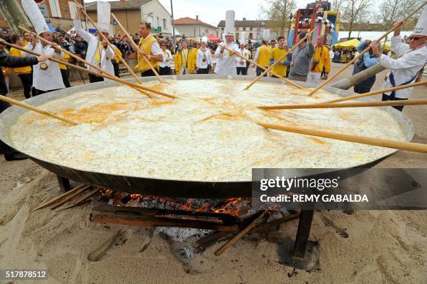 Members of the Giant Omelette Brotherhood of Bessieres cook a giant omelette as part of Easter celebrations on March 28 on the main square of...