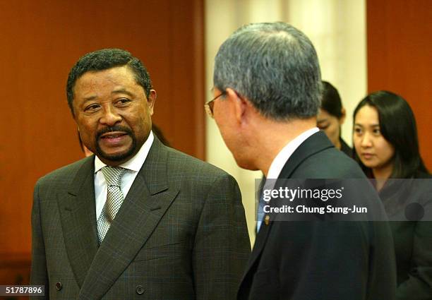 General Assembly President Jean Ping talks with South Korean Foreign Minister Ban Ki-Moon before a meeting at Ban's office November 24, 2004 in...