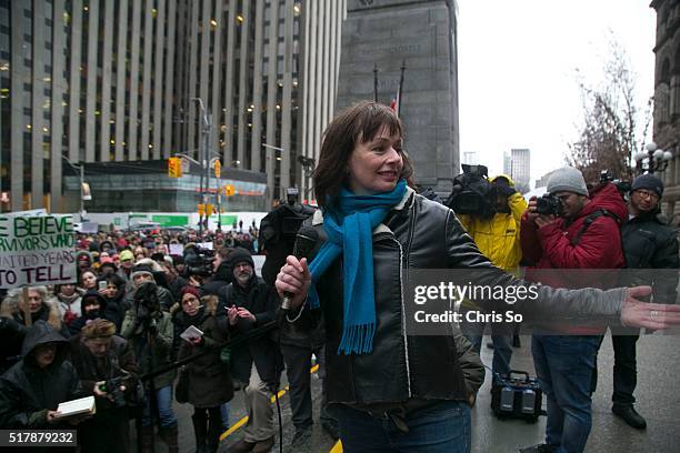 After addressing a few hundred supporters gathered outside Old City Hall, witness Lucy DeCoutere introduces "Witness No. 1" whose identity is under a...