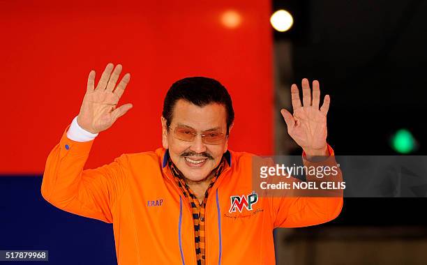 Former Philippine President Joseph Estrada waves to his supporters during his proclamation rally, running for his second term as Mayor in Manila on...