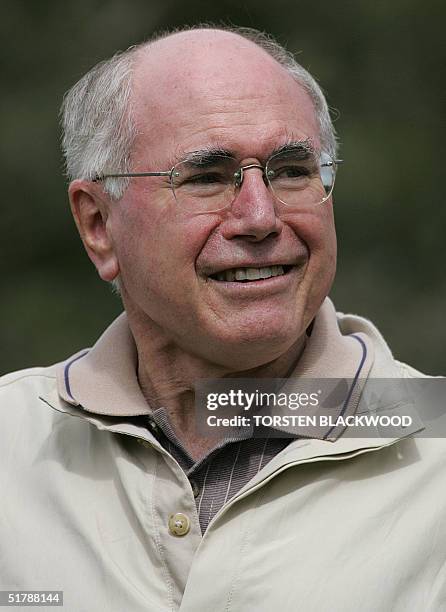 Australian Prime Minister John Howard watches American golfing icon Arnold Palmer, Australian greats Bruce Devlin and Peter Thomson playing a...