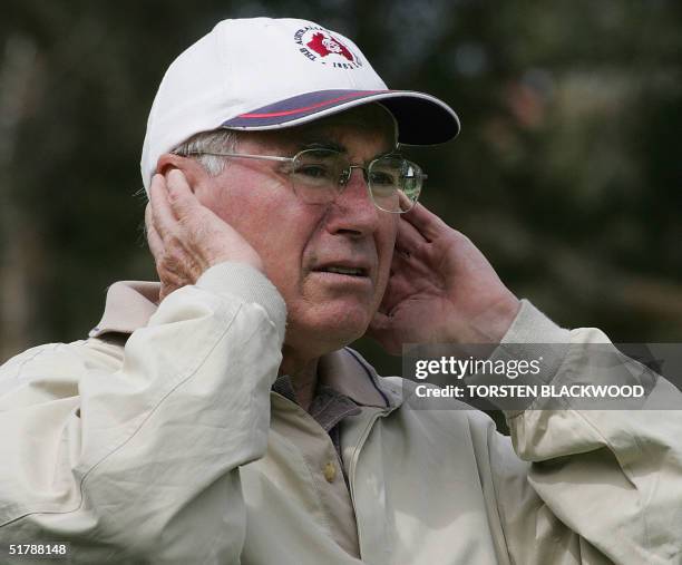 Australian Prime Minister John Howard watches American golfing icon Arnold Palmer, Australian greats Bruce Devlin and Peter Thomson playing a...