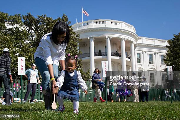 One year-old Ava Johnson plays a game during the annual White House Easter Egg Roll on the South Lawn of the White House March 28, 2016 in...