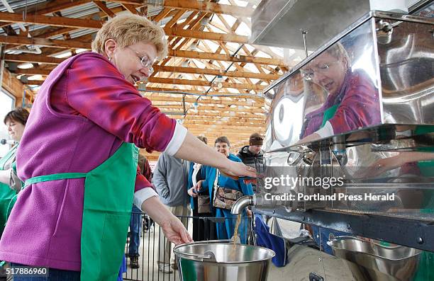 Brenda Boston drains some maple syrup out of the evaporator during Maine Maple Sunday on Sunday, March 27, 2016 at Chase Farm in Wells, Maine.