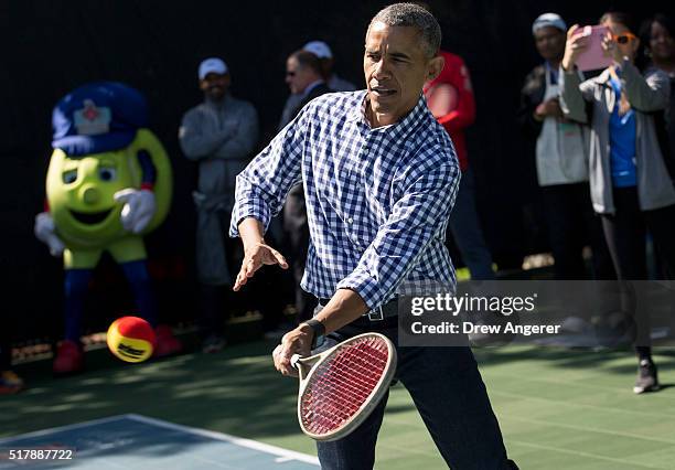 President Barack Obama plays tennis with children during the annual White House Easter Egg Roll on the South Lawn of the White House March 28, 2016...