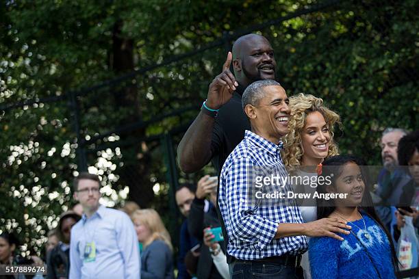 President Barack Obama poses for a photo with former NBA player Shaquille O'Neal and reality television personality Nicole "Hoopz" Alexander on the...
