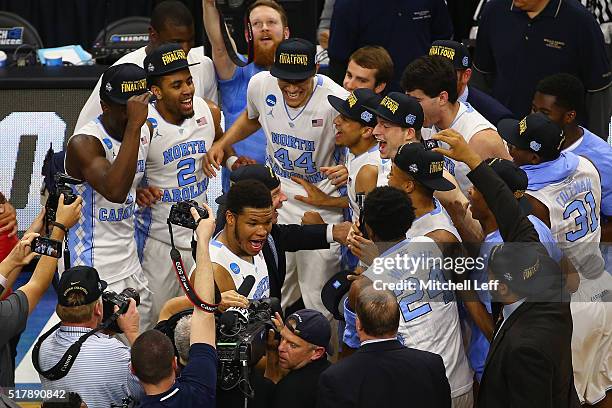 Head coach Roy Williams and Kennedy Meeks of the North Carolina Tar Heels celebrate with their team after defeating the Notre Dame Fighting Irish...