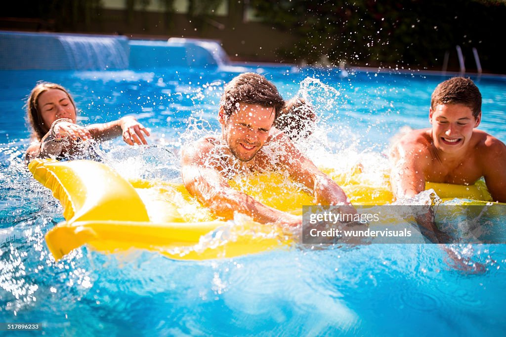 Friends Sharing Lilo in Pool