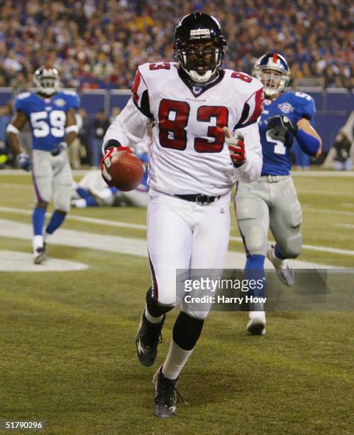Tight end Alge Crumpler of the Atlanta Falcons carries the ball into the end zone during the game against the New York Giants at Giant Stadium on...