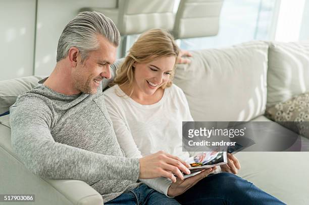 couple relaxing at home - ad magazine stockfoto's en -beelden