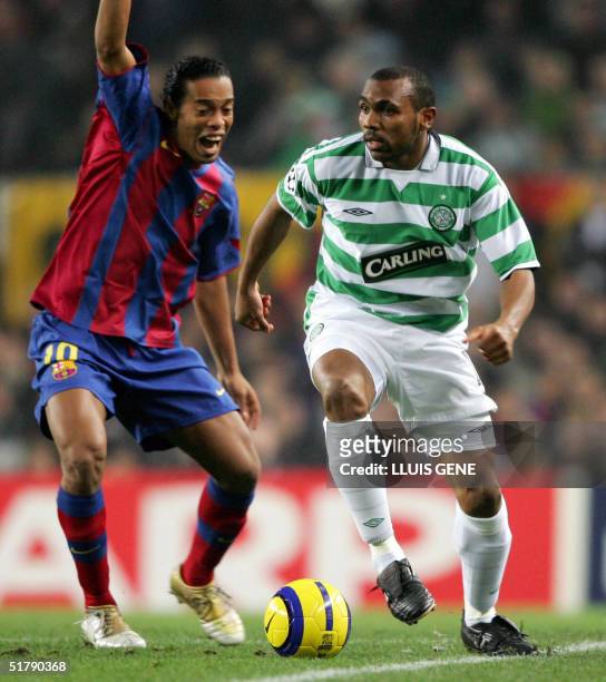 Barcelona's Brazilian Ronaldinho vies with Celtic's Didier Agathe during their Champions League football match at the Camp Nou stadium in Barcelona,...