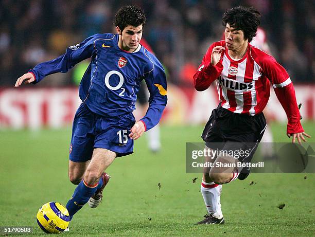 Cesc Fabregas of Arsenal beats Ji-Sung Park of PSV Eindhoven during the UEFA Champions League Group E match between PSV Eindhoven and Arsenal at the...