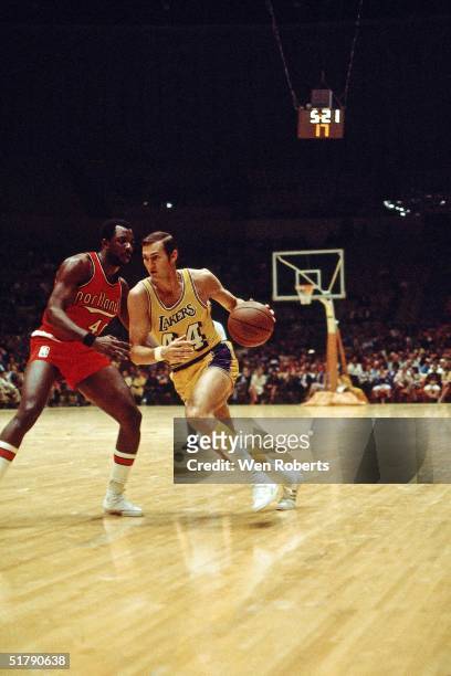Jerry West of the Los Angeles Lakers drives against the Portland Trailblazers during the NBA game in Los Angeles, California. NOTE TO USER: User...